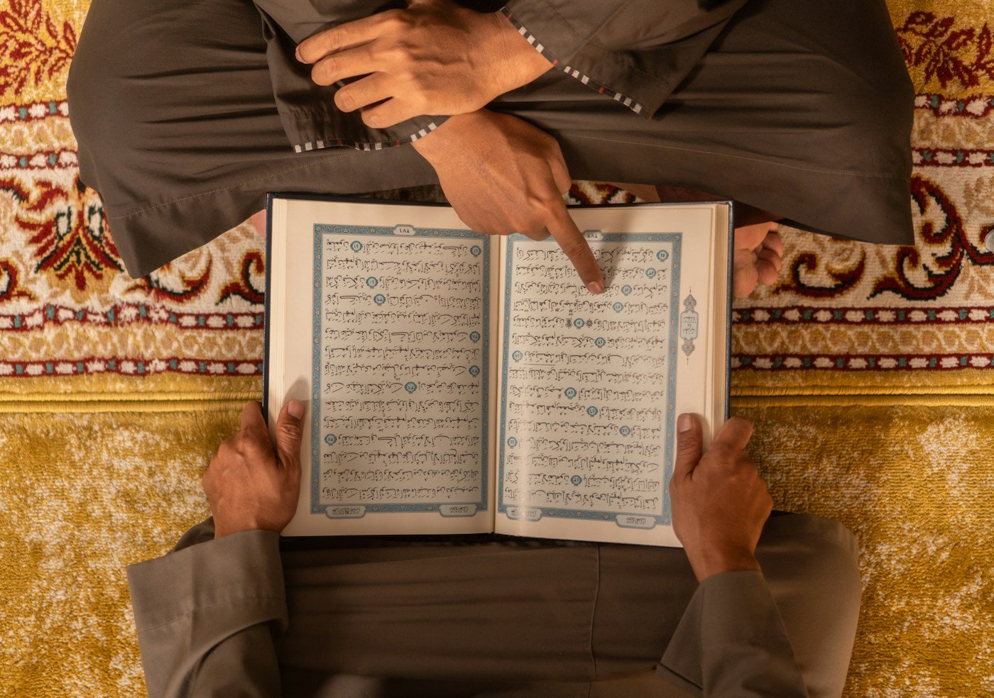Two people reading the Quran together